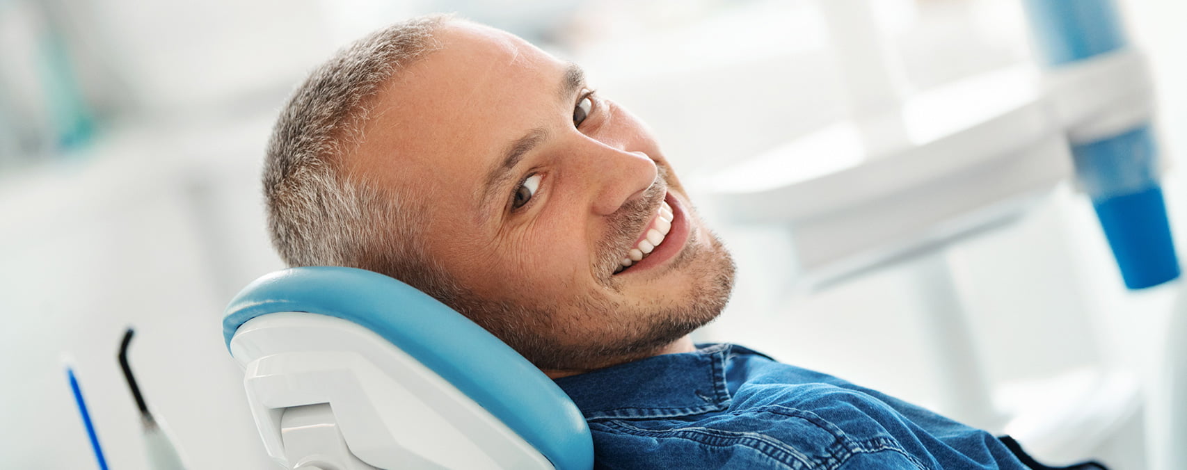 man sitting in dentist chair dentist in euless