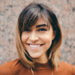 young woman smiles showing off her dental veneers dentist in euless