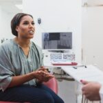 woman asking dentist if cavity under dental crown can be treated