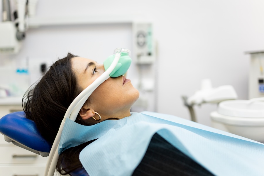 woman using dental sedation nitrous oxide at the dentist